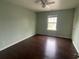 This bedroom features a ceiling fan, window with natural light, and dark hardwood flooring at 2166 Villa Spring Ct, Dacula, GA 30019