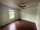 Bedroom with hardwood floors, neutral paint and ceiling fan and window offering natural light at 2166 Villa Spring Ct, Dacula, GA 30019