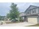 This house shows coordinating shutters, landscaping, and a lawn in front of the two-car garage at 2166 Villa Spring Ct, Dacula, GA 30019