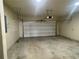 Empty two car garage with sealed cement floors and automatic door opener at 2166 Villa Spring Ct, Dacula, GA 30019