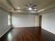 Spacious main bedroom with tray ceiling, hardwood floors, ceiling fan and neutral paint at 2166 Villa Spring Ct, Dacula, GA 30019