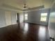 Spacious main bedroom featuring tray ceilings, ceiling fan and dark wood floors and natural light at 2166 Villa Spring Ct, Dacula, GA 30019