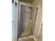 Shower with glass door, marble-look tile and overhead shower head fixture at 2166 Villa Spring Ct, Dacula, GA 30019
