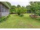 Lush backyard with vibrant green lawn, mature trees, and patio area at 4812 Pamela Nw Ct, Acworth, GA 30101