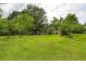 Large grassy backyard with mature trees and landscaping, including a shed at 4812 Pamela Nw Ct, Acworth, GA 30101