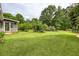 Serene backyard with an inviting green lawn, mature trees and screened-in porch, creating a peaceful oasis at 4812 Pamela Nw Ct, Acworth, GA 30101