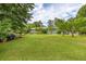 Large grassy backyard surrounded by mature trees and landscaping at 4812 Pamela Nw Ct, Acworth, GA 30101