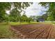 Large backyard with manicured lawn, garden, and lush landscaping at 4812 Pamela Nw Ct, Acworth, GA 30101