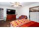 Bedroom featuring dark wood floors, a large closet, TV, and a couch at 4812 Pamela Nw Ct, Acworth, GA 30101