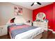 Bedroom showcasing hardwood floors, neutral and red walls, and white dresser at 4812 Pamela Nw Ct, Acworth, GA 30101