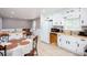 Open kitchen area with white cabinetry, tile floor, and adjacent eating area at 4812 Pamela Nw Ct, Acworth, GA 30101