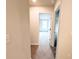 Bright hallway featuring neutral walls and carpeted floors leading to bedrooms at 5342 Legacy Trl, Douglasville, GA 30135