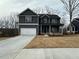 A newly constructed two-story house features a front-facing garage, covered porch, and modern design at 5547 Bent Grass Way, Douglasville, GA 30135