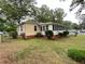 View of back exterior of home showing fenced in backyard with mature trees and lawn at 5760 Brenda Sw Dr, Mableton, GA 30126