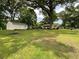 Spacious backyard with a large lawn and detached garage surrounded by mature trees at 5760 Brenda Sw Dr, Mableton, GA 30126
