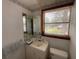 Neat half-bathroom with modern fixtures and cabinetry at 5760 Brenda Sw Dr, Mableton, GA 30126