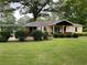 Well-maintained, charming yellow home with attached carport on a large, grassy lot at 5760 Brenda Sw Dr, Mableton, GA 30126