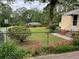 Cozy home featuring lush front yard landscaping, sidewalk and chain link fence at 5760 Brenda Sw Dr, Mableton, GA 30126