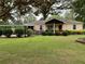 Single-story home featuring a welcoming front yard, carport, and landscaped garden at 5760 Brenda Sw Dr, Mableton, GA 30126