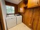 Functional laundry room showcasing a modern washer, dryer, and practical overhead cabinets at 5760 Brenda Sw Dr, Mableton, GA 30126