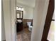 View of a downstairs half bathroom featuring tile flooring and a modern sink at 6848 Timberhead Way, Lithonia, GA 30058