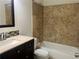 Bathroom featuring a stylish vanity, bathtub and shower combination with travertine tile at 6848 Timberhead Way, Lithonia, GA 30058
