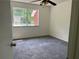 Carpeted bedroom featuring a ceiling fan and window view of the outdoors at 6848 Timberhead Way, Lithonia, GA 30058