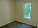 Cozy bedroom with neutral carpet and a bright window view of lush greenery at 6848 Timberhead Way, Lithonia, GA 30058