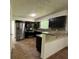 Open kitchen with stainless steel appliances, dark cabinets, and granite countertops at 6848 Timberhead Way, Lithonia, GA 30058