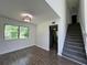 Charming living space with hardwood floors, large windows, and convenient staircase at 6848 Timberhead Way, Lithonia, GA 30058