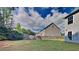 Spacious backyard with lush green grass, privacy fence, and mature trees at 8256 Milam Loop, Fairburn, GA 30213
