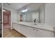 Bathroom with double sinks, white cabinets, and a full-length mirror at 8256 Milam Loop, Fairburn, GA 30213