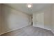 Cozy bedroom featuring neutral carpet, ample natural light, and a closet with double doors at 8256 Milam Loop, Fairburn, GA 30213