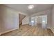 Open-concept living area with light colored vinyl flooring, staircase, and views to the backyard at 8256 Milam Loop, Fairburn, GA 30213