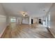 Expansive living area showcasing light flooring, ceiling fan, and seamless flow to kitchen at 8256 Milam Loop, Fairburn, GA 30213