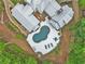 Aerial view of the home, featuring a pool, outdoor seating, and lush landscaping at 8901 Watkins Mill Rd, Winston, GA 30187