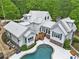 Aerial view of the back of the home, featuring a pool and outdoor seating area at 8901 Watkins Mill Rd, Winston, GA 30187