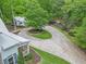 Aerial view of the home with a large circular driveway and lush green landscaping at 8901 Watkins Mill Rd, Winston, GA 30187