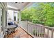 Inviting back porch featuring white railings and furniture with beautiful views of wooded backyard at 8901 Watkins Mill Rd, Winston, GA 30187