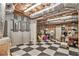 Spacious basement area with a checkered floor and open ceiling at 8901 Watkins Mill Rd, Winston, GA 30187