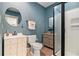 Quaint bathroom with a frameless shower, decorative mirror, and bright vanity at 8901 Watkins Mill Rd, Winston, GA 30187