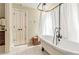 Bathroom featuring clawfoot tub with shower, tile flooring, and neutral paint at 8901 Watkins Mill Rd, Winston, GA 30187