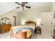 Cozy bedroom with soft carpet, ceiling fan, and a classic wooden bed frame at 8901 Watkins Mill Rd, Winston, GA 30187