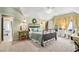 Bright bedroom featuring a decorative metal bed frame, ceiling fan, and ensuite bathroom at 8901 Watkins Mill Rd, Winston, GA 30187