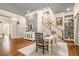 Elegant dining room with hardwood floors, chandelier, staircase, and built in shelving for decor at 8901 Watkins Mill Rd, Winston, GA 30187