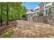 Gravel driveway lined with mature trees leading to a beautifully landscaped home at 8901 Watkins Mill Rd, Winston, GA 30187