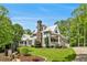 Beautiful home with stone accents, covered porches, and a lush green lawn at 8901 Watkins Mill Rd, Winston, GA 30187