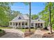 Stunning two-story home boasting a metal roof, a welcoming front porch, and meticulous landscaping at 8901 Watkins Mill Rd, Winston, GA 30187