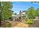 Charming two-story home featuring a stone chimney, covered porch, and meticulous landscaping, nestled among mature trees at 8901 Watkins Mill Rd, Winston, GA 30187