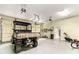 Spacious garage with high ceilings and convenient overhead door mechanisms, plus yard and garden equipment at 8901 Watkins Mill Rd, Winston, GA 30187